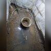 Water intrusion is an issue in this basement. Standing water is visible, and the floor around it is muddy.