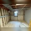 Multiple anchors are strategically installed along the basement wall to evenly distribute pressure and restore structural stability across the room.