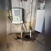 This homeowner's old sump pump lacked the capacity and reliability to handle incoming water, allowing moisture to build up during heavy rains and causing ongoing seepage in the basement.