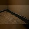 The pipes are laid above the footing to prevent dirt from getting into the drain.