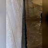 A photo of the WaterGuard drainage system being installed in the basement.