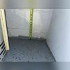 A tape measure reveals previous water line marks on the basement wall, showing just how high moisture levels had risen before the waterproofing system was installed.
