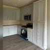New drywall, paint, electrical, plumbing, flooring, cabinets, and appliances were installed to rebuild the house to its pre-loss condition. A new Samsung Gas Griddle Stove was installed to match the microwave. Additionally, the grey paneled kitchen cabinets were installed to complement the popular...
