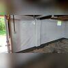 The vapor barrier tucks into the WaterGuard wall flange, allowing the walls to leak down into the subfloor drainage system.