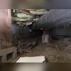 This photo shows the crawl space in its original condition-cluttered with debris and exposed dirt.