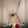 The original sump pump the homeowner had that wasn't fully pumping water out from the basement.