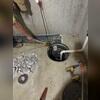 The team digs along the interior perimeter. Pipes collect the water and bring it to the sump pump shown above.