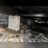 Water stains climbing the brick foundation and visible humidity on the ceiling and floor of this crawl space point to chronic moisture issues. These signs often lead to mold, wood decay, and compromised structural integrity if not addressed promptly.