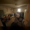 Stove, refrigerator, washer, dryer, piles of cardboard boxes and trash, clothing, end tables, two bicycles, couch, sleeper sofa, queen bedframe and mattress, and junk removed in Grapevine, TX