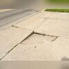 This section of the Clinton, IA driveway shows significant settling and fracturing, a common issue that, if left unaddressed, can lead to more extensive and costly repairs, potentially requiring full replacement. The homeowner wisely recognized the urgency of addressing this deterioration...