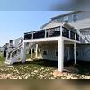 White-wrapped columns and trim details give the underdeck area a clean, polished look, while the DekDrain system above keeps it fully protected from water