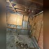 The basement prior to waterproofing and finishing, an uninviting space prone to moisture issues and lacking insulation or usable features.