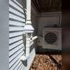 RN-2 fan installed near the porch corner, powering the dual extraction system for consistent airflow.