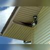 The raccoon was able to accomplish that by climbing the downspout and pushing through the soffit above the downspout elbow.