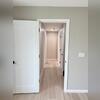 View of the new hallway that leads to the bedrooms and bathroom. the stairwell into the basement can also be seen on the right.