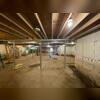 A wide view of the basement after our team secured the structure with SmartJack® support posts and heavy-duty steel beams. The result is a level, stable floor above and enhanced structural integrity.