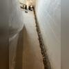 A trench is dug along the perimeter of the basement to get ready to install the drainage system. As you can see in the photo, the sump pump is placed at the lowest point of the basement, and all the trenches that are dug lead to this point.