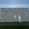 Before the soft wash, the vinyl siding on this home was covered in grime.