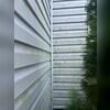 Before the soft wash, the vinyl siding on this home was covered in green grime and buildup.