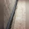 Once weep holes are drilled, WaterGuard is placed just below the floor slab's edge, then covered with clean stone and a new concrete layer, creating a clean, concealed, and highly effective drainage channel.