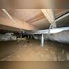 Our crew works in the crawl space to install SmartJack support posts, providing much-needed stability to the sagging floor above.