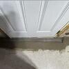 TrenchDrain is installed in front of the basement door that leads outside to catch excess and surface water.