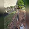 Progress photo of the installation of the discharge line. Once water is pumped out of the basement, it travels through this hidden line to a safe distance from the home.
