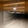 A heavy-duty liner covers the entire crawl space floor and walls, creating a continuous barrier against moisture and humidity.
