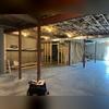 Here you can see the unfinished basement walls and the concrete floor that are exposed. The waterproofing system has not be installed quite yet.