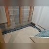 Our WaterGuard System rests in a bed of drainage stone and sits on top of the foundation footing. This is so it is out of the "mud zone" where it can become clogged with dirt or debris.