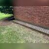 The current gutters are not catching heavy rains the way they should. During heavy storms, the water is overflowing the open-faced gutter system. You can see how the soil is washing away and allowing water to sink into the foundation.