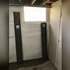 This photo shows after we installed our CleanSpace vapor barrier along the wall, installed our WaterGuard drains underneath the floor, and attached our C-channel wall anchors to the tie-backs.