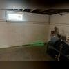 Our laser level allows us to look for a couple of things. For one, it helps us determine the low spot in the basement, where we'll install the sump pump. It also helps us look for any signs of settlement or wall deflection.