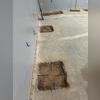 After the piers are secured, the concrete slab is patched and prepared for flooring restoration inside the home.
