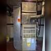 This furnace is really ancient! It is only about 65% efficient and uses a chimney which can pose a carbon monoxide problem if the chimney ever clogs. It's got to go!