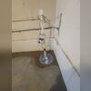 The sump pump system is fully installed and ready to protect the basement from future water buildup.
