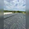 Once the roof was dried in, we installed new starter shingles, field shingles, and hip and ridge.