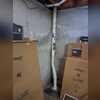 Pipe installed at the rear corner of the home for efficient radon ventilation.