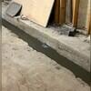 WaterGuard is installed along the perimeter of the basement floor and covered in fresh concrete to provide a seamless finished look. The WaterGuard Port is left visible to provide access to the system when needed.
