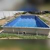 The pool liner is carefully positioned and smoothed to fit perfectly over the base, creating a seamless, durable surface that brings the pool closer to completion.