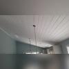 We installed new ceiling planks in white. This Tongue & Groove style works as a sound barrier between the 1st and second floor while providing a warm, wood finish that adds class to any home.