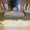 WaterGuard is installed along the perimeter of the basement floor and covered in fresh concrete to provide a seamless finished look. Our crew did a great job installing the drainage system around this fire place. The WaterGuard Port is left visible to provide access to the system when needed.