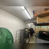 This wall is opposite the space he uses for exercise. It's the perfect location because the air will blow across the garage towards his gym area. His car will also be more comfortable when he gets into it in the morning.