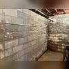 In this Kernersville basement, severe foundation problems were visible before repairs began. Horizontal cracks ran along the block wall, a clear indicator of hydrostatic pressure from the surrounding soil pushing inward. Water stains and efflorescence showed long-term moisture issues, further...