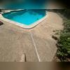 Concrete pool deck settlement is often caused by poor soil compaction during construction, water erosion beneath the slab, or soil shrinkage due to drought conditions. These factors create voids under the concrete, leading to uneven sinking and cracking over time.