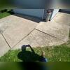 The driveway slabs had settled unevenly, creating cracks and trip hazards near the garage entry.