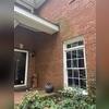 The walls are discolored from the water over-shooting and slashing against the brick wall. We are going to install a new section of gutter to alleviate the issue.