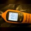 Checking the humidity levels in the crawl space during the inspection.
