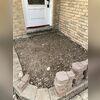 The push piers are now covered in dirt and the stones will be used to finish the landscaping