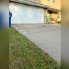 This photo highlights the challenge this Bettendorf, IA homeowner faced. They were fed up with the settled and cracked concrete creating a bothersome bump right at the garage entry, a major inconvenience, especially with a brand-new car! Luckily, we were able to bring the driveway back to life...